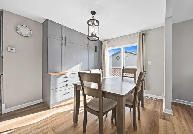 a view of a dining room with furniture window and wooden floor