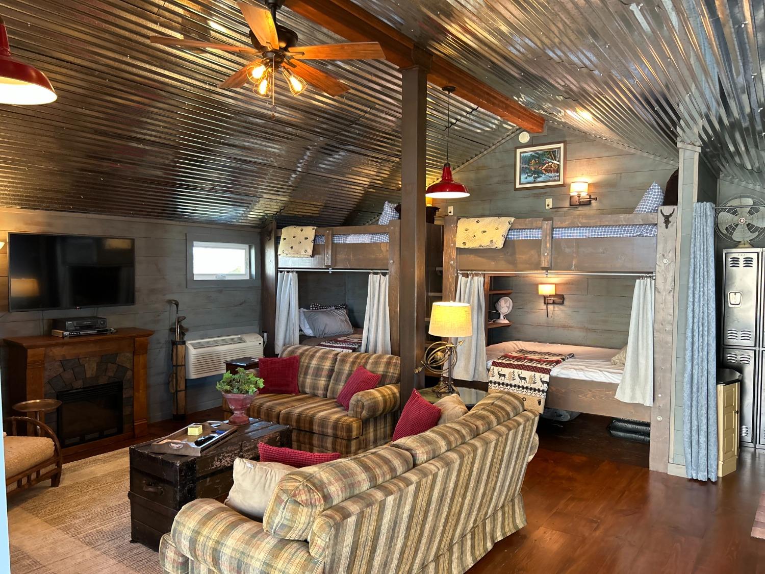 4756 East Rannells Road North Knox, IN 46534 - Photo 24 of 34 a living room with furniture a flat screen tv and a fireplace