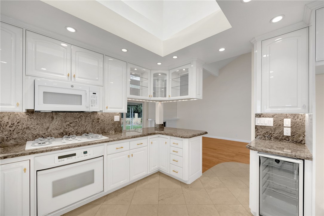 485 Castlegate Lane Brea, CA 92821 - Photo 11 of 41 a kitchen with granite countertop white cabinets and white appliances