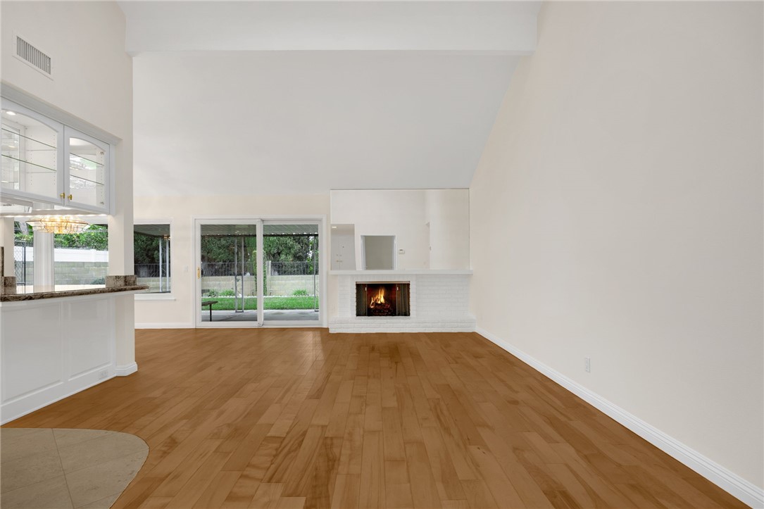 485 Castlegate Lane Brea, CA 92821 - Photo 4 of 41 a view of an empty room with wooden floor and a window