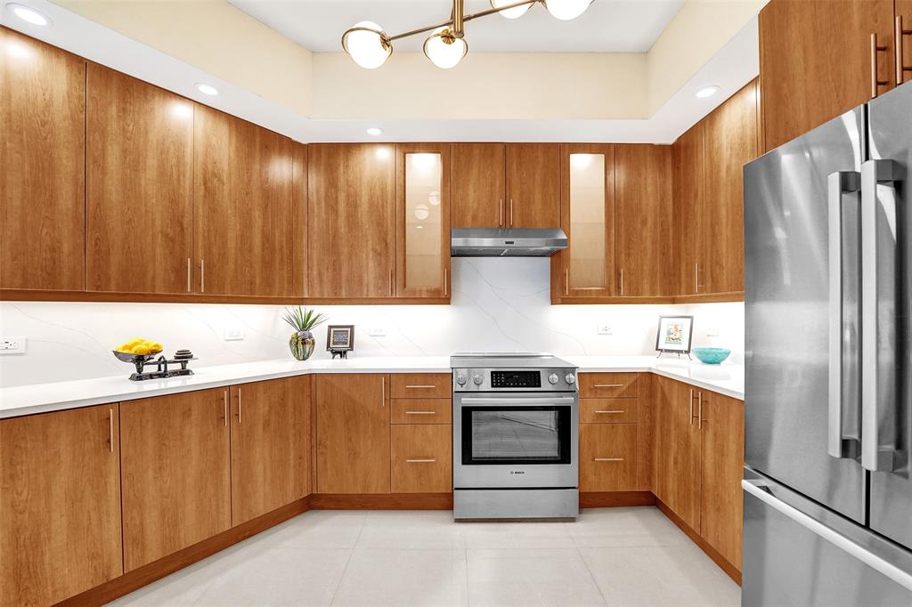 2617 Northeast 14th Avenue, Unit 507 Wilton Manors, FL 33334 - Photo 11 of 65 a kitchen with stainless steel appliances a stove top oven