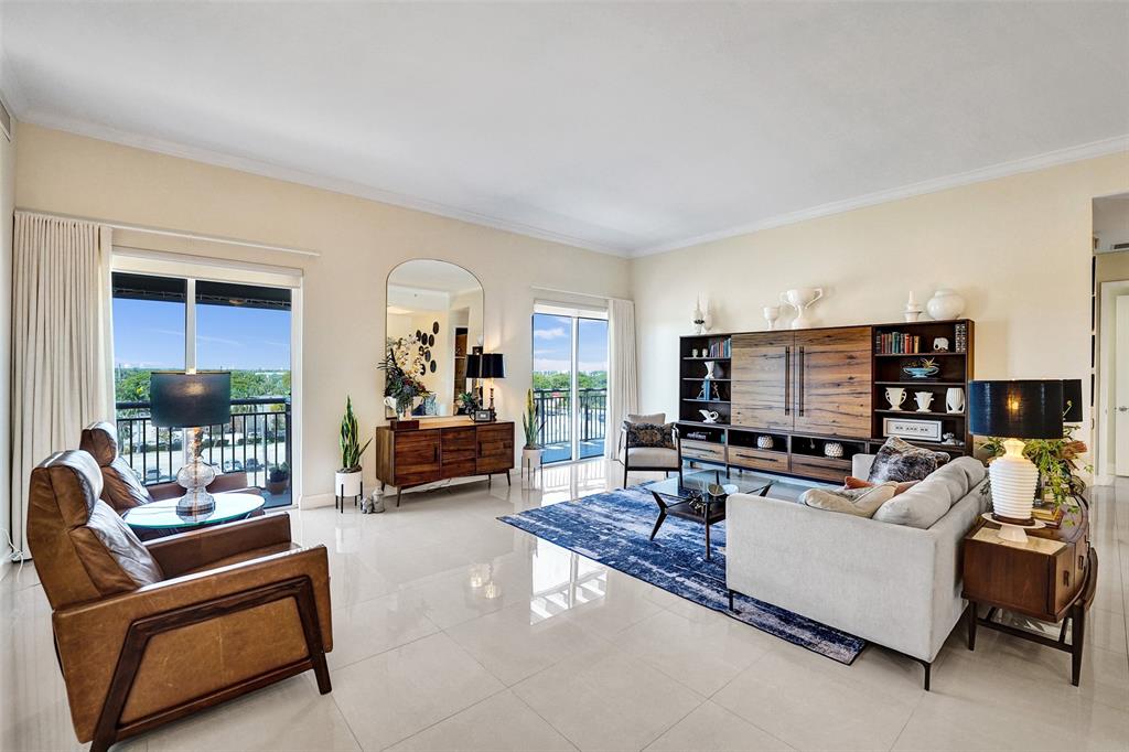 2617 Northeast 14th Avenue, Unit 507 Wilton Manors, FL 33334 - Photo 2 of 65 a living room with furniture and a flat screen tv