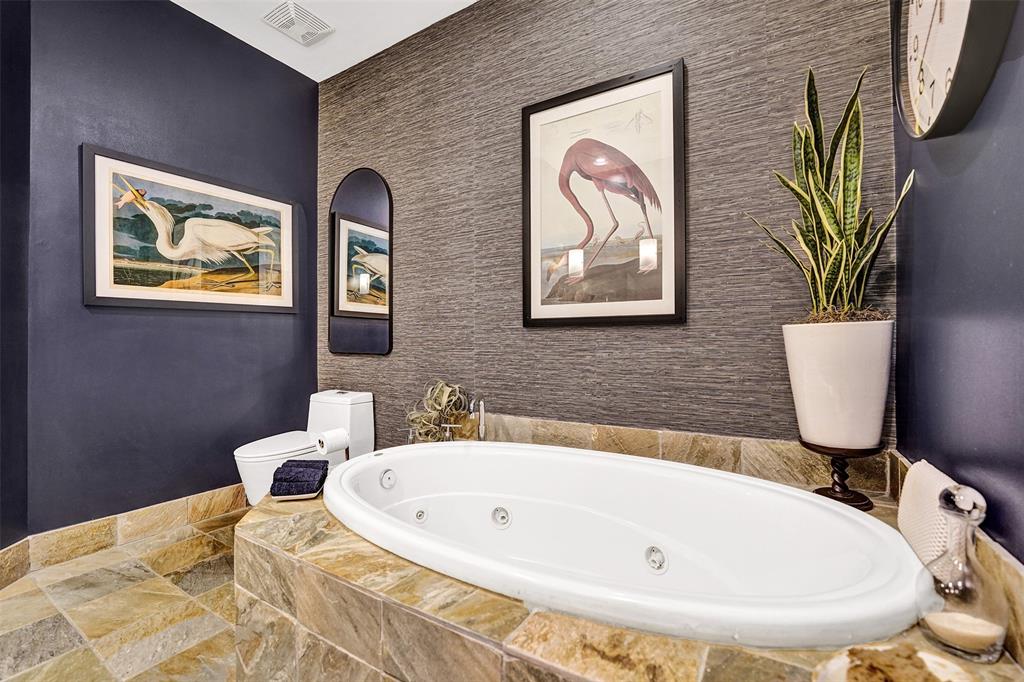 2617 Northeast 14th Avenue, Unit 507 Wilton Manors, FL 33334 - Photo 21 of 65 a bathroom with a sink a bathtub and a painting on the wall