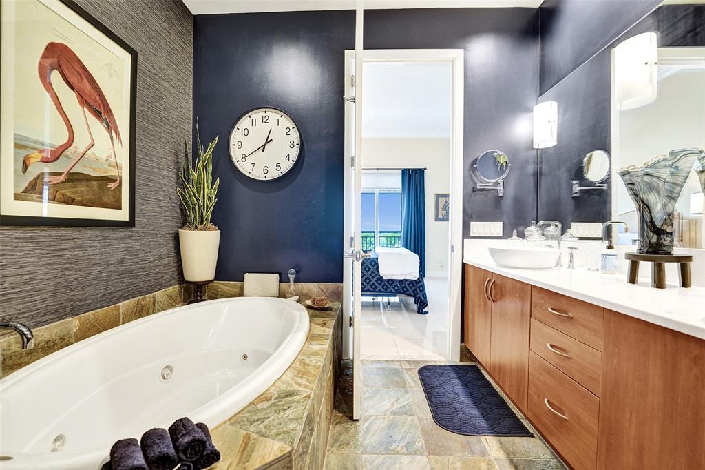 2617 Northeast 14th Avenue, Unit 507 Wilton Manors, FL 33334 - Photo 22 of 65 a bathroom with a tub sink and mirror