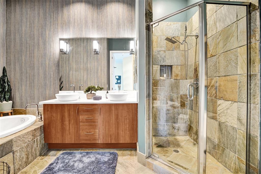 2617 Northeast 14th Avenue, Unit 507 Wilton Manors, FL 33334 - Photo 27 of 65 a bathroom with a granite countertop sink a mirror a shower and a bathtub