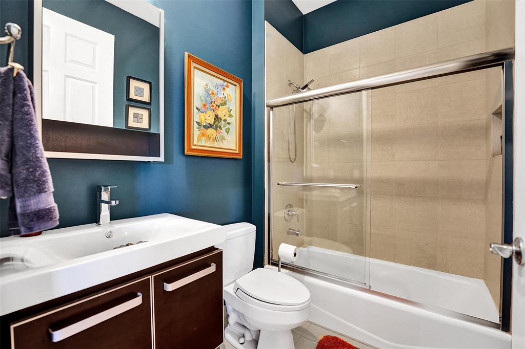 2617 Northeast 14th Avenue, Unit 507 Wilton Manors, FL 33334 - Photo 33 of 65 a bathroom with a sink a toilet and shower