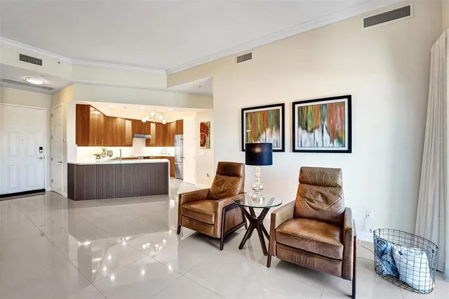 a living room with furniture a window and a flat screen tv
