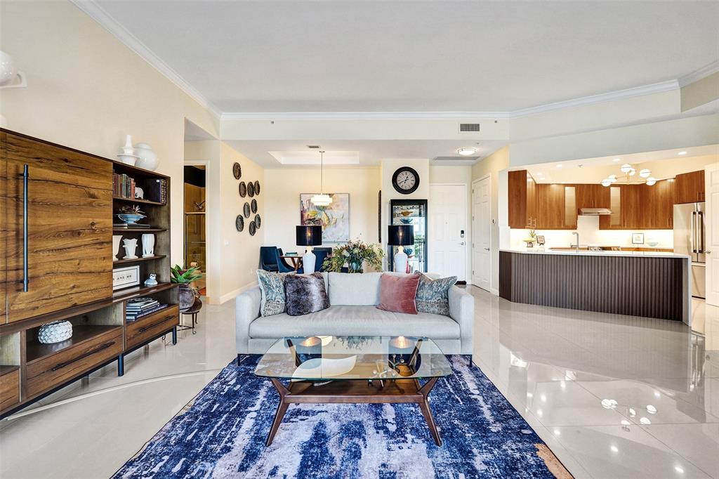 2617 Northeast 14th Avenue, Unit 507 Wilton Manors, FL 33334 - Photo 6 of 65 a living room with furniture and a flat screen tv