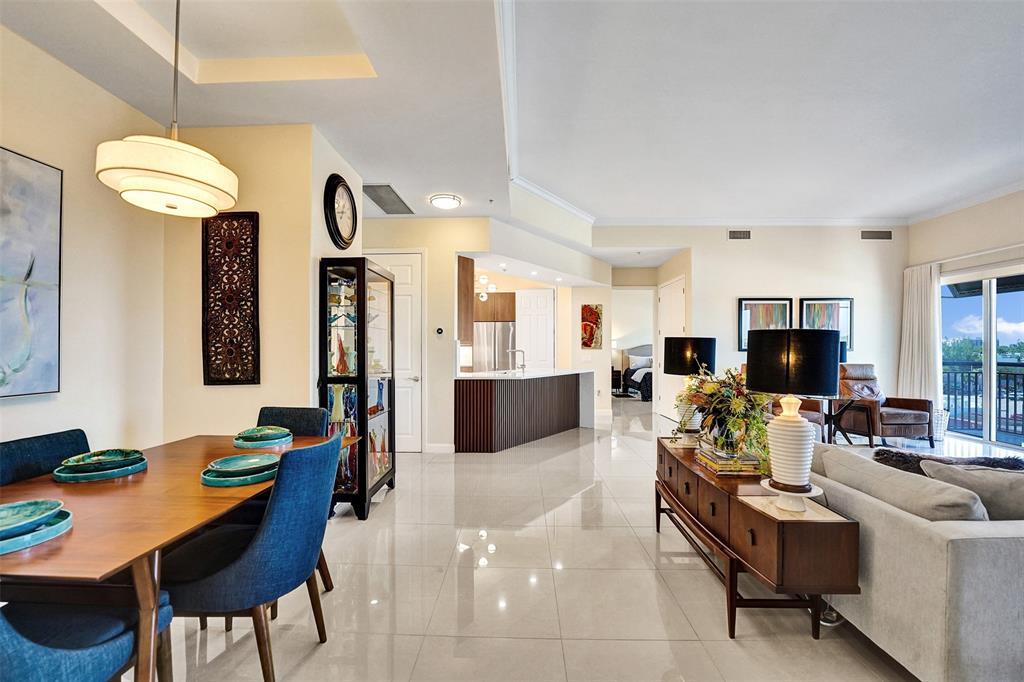 2617 Northeast 14th Avenue, Unit 507 Wilton Manors, FL 33334 - Photo 7 of 65 a living room with furniture kitchen view and a chandelier