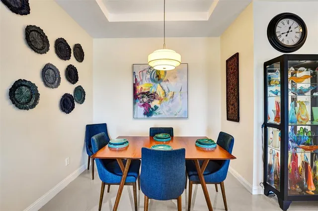a view of a dining room with furniture and chandelier