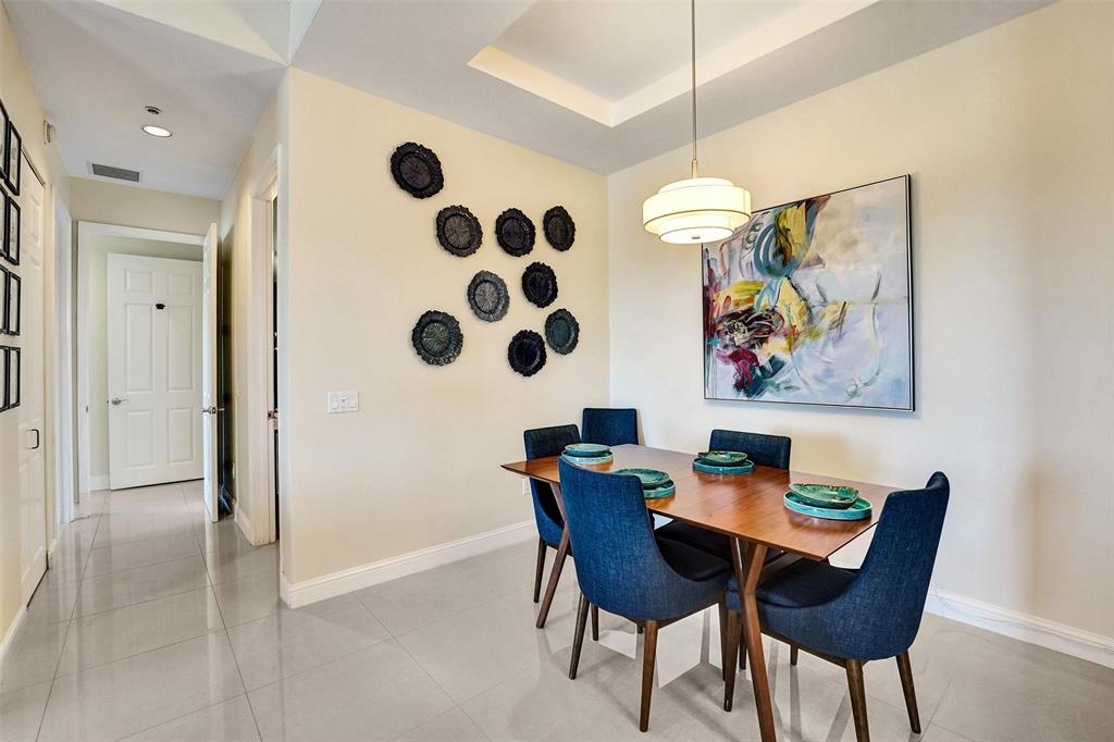 2617 Northeast 14th Avenue, Unit 507 Wilton Manors, FL 33334 - Photo 9 of 65 a view of a dining room with furniture and chandelier