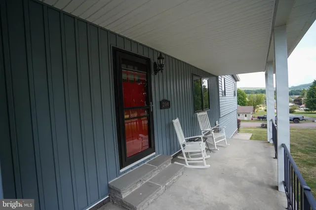 a kitchen with granite countertop a refrigerator oven a sink a stove and cabinets