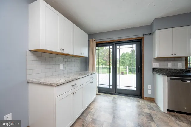 a view of an empty room with a fireplace and a window