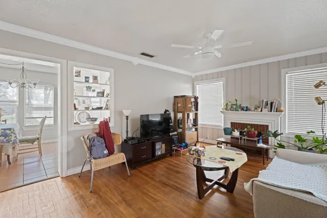 a living room with furniture a fireplace and a flat screen tv