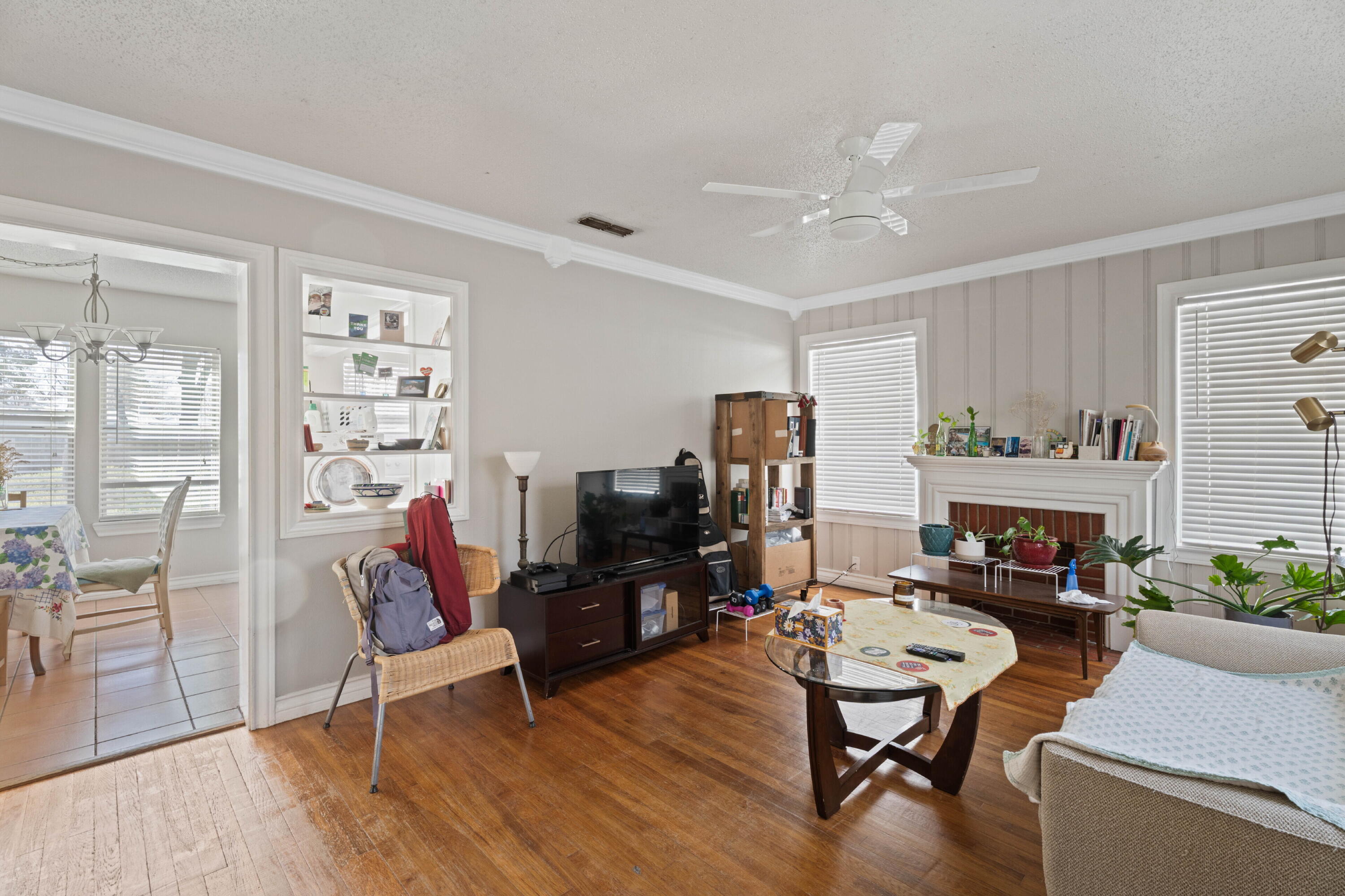 2703 23rd Street Lubbock, TX 79410 - Photo 3 of 11 a living room with furniture a fireplace and a flat screen tv