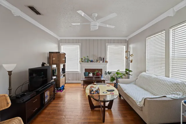 a living room with furniture fireplace and flat screen tv