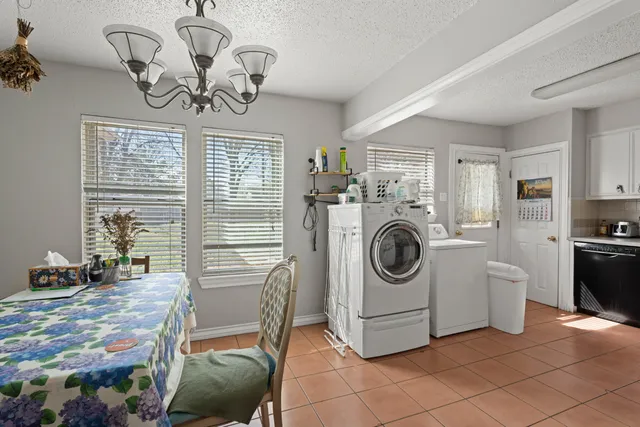 a view of a livingroom with furniture washer and dryer