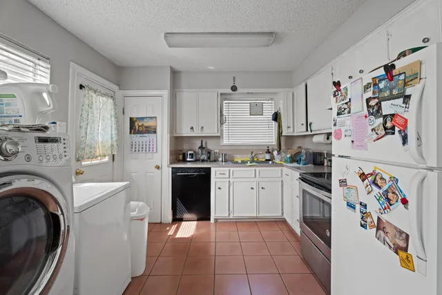 a kitchen with stainless steel appliances granite countertop a refrigerator sink stove and cabinets
