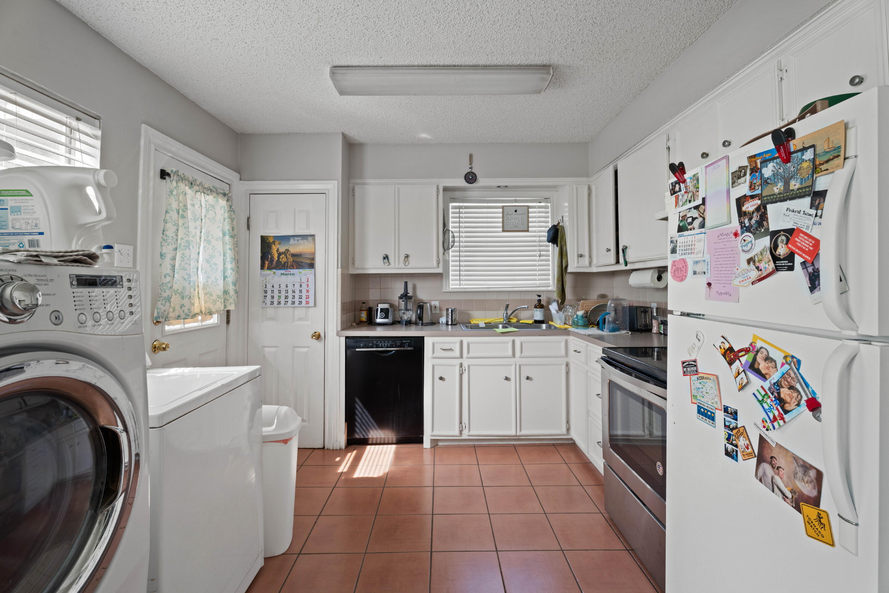2703 23rd Street Lubbock, TX 79410 - Photo 6 of 11 a kitchen with stainless steel appliances granite countertop a refrigerator sink stove and cabinets