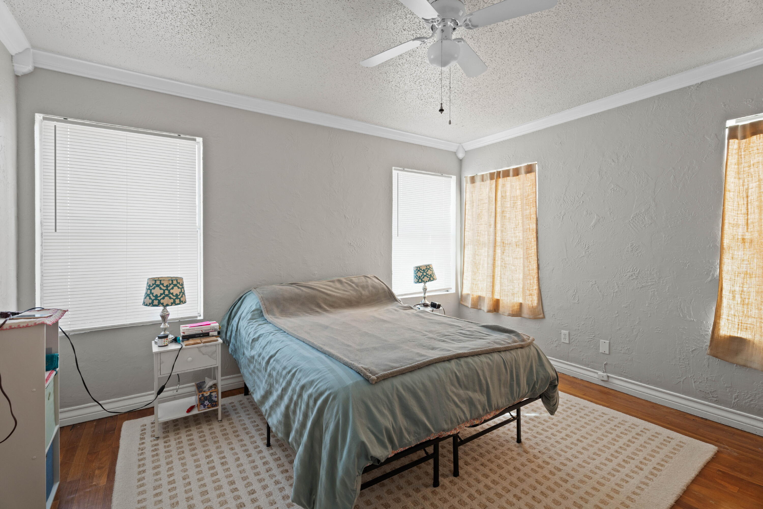 2703 23rd Street Lubbock, TX 79410 - Photo 10 of 11 a bed sitting in a bedroom next to a window