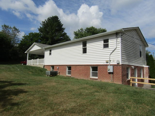 3633 Childress Road Christiansburg, VA 24073 - Photo 15 of 17 a front view of a house with a garden