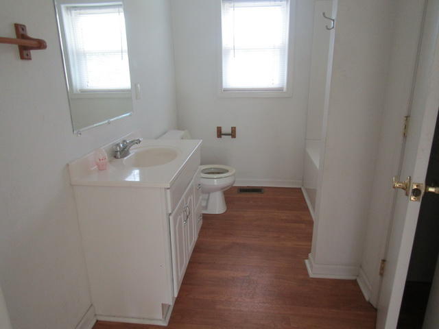 3633 Childress Road Christiansburg, VA 24073 - Photo 6 of 17 a bathroom with a sink a toilet and a window