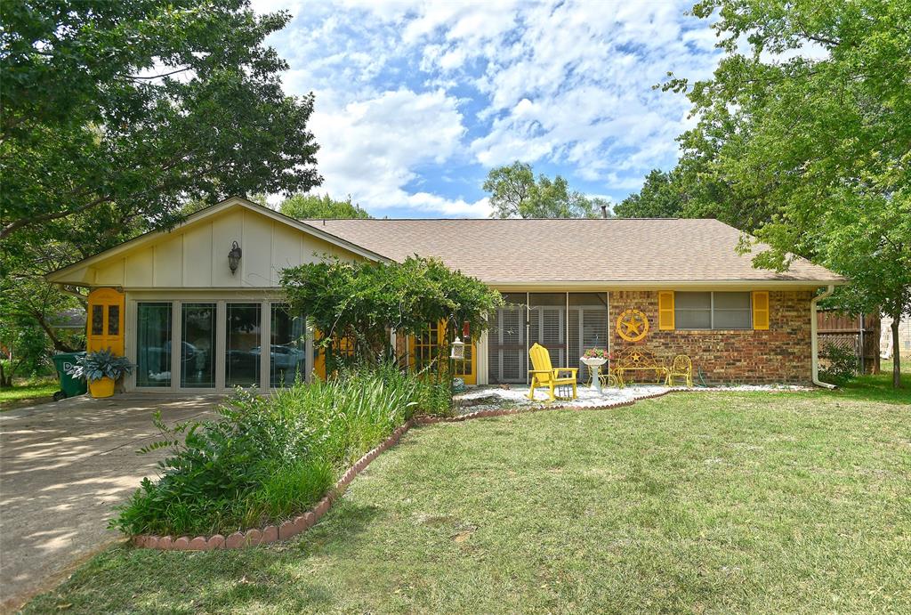 618 Magnolia Street Denton, TX 76201 - Photo 1 of 1 a front view of a house with a yard table and chairs