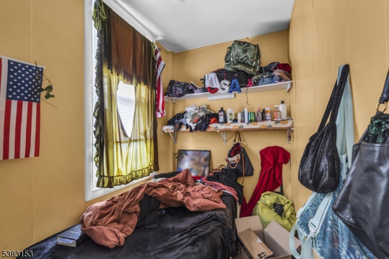 433 3rd Avenue Elizabeth Port, NJ 07206 - Photo 11 of 36 a bedroom with a bed and a window