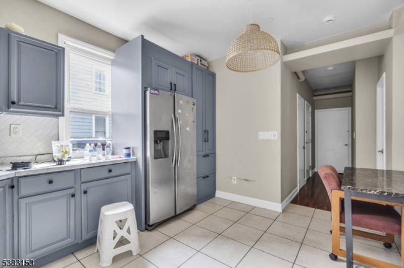 433 3rd Avenue Elizabeth Port, NJ 07206 - Photo 16 of 36 a kitchen with stainless steel appliances a refrigerator and a stove
