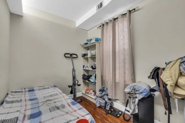 a bedroom with bed and a mirror