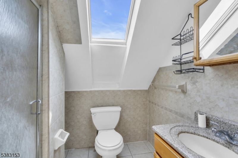 433 3rd Avenue Elizabeth Port, NJ 07206 - Photo 26 of 36 a bathroom with a granite countertop toilet and a sink