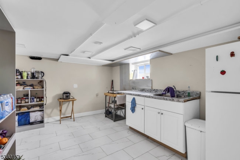 433 3rd Avenue Elizabeth Port, NJ 07206 - Photo 30 of 36 a kitchen with a sink and cabinets