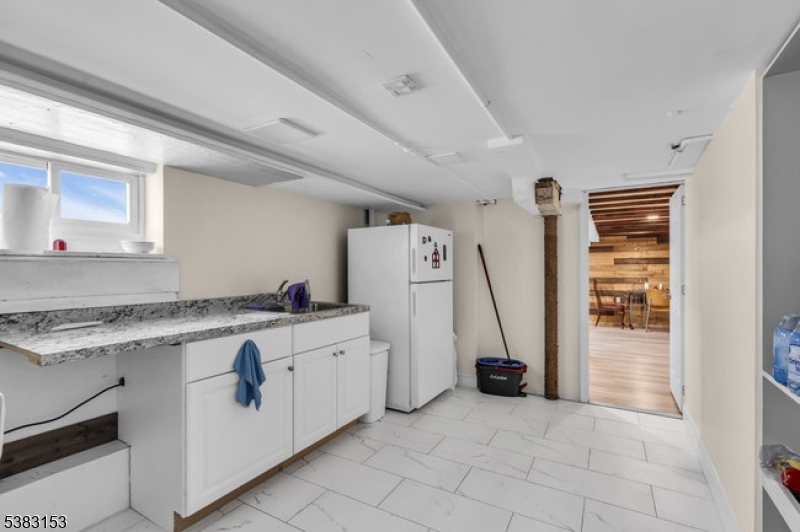 433 3rd Avenue Elizabeth Port, NJ 07206 - Photo 31 of 36 a view of a kitchen with refrigerator and washing machine