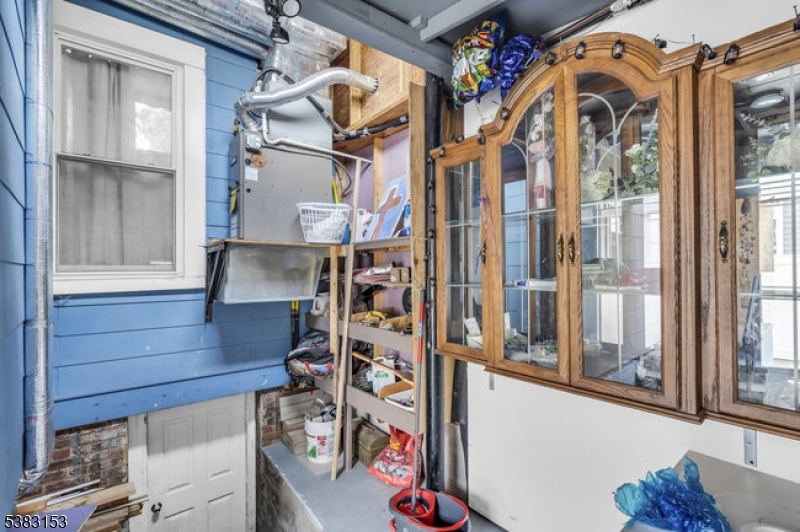 433 3rd Avenue Elizabeth Port, NJ 07206 - Photo 33 of 36 a view of walk in closet with clothes and shoes