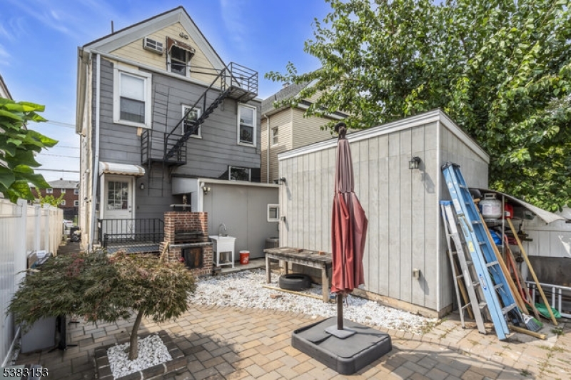 433 3rd Avenue Elizabeth Port, NJ 07206 - Photo 35 of 36 a view of a house with backyard and trees