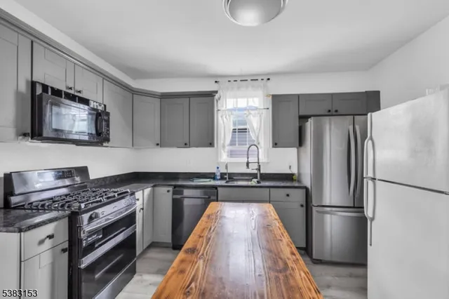 a kitchen with a refrigerator stove and sink