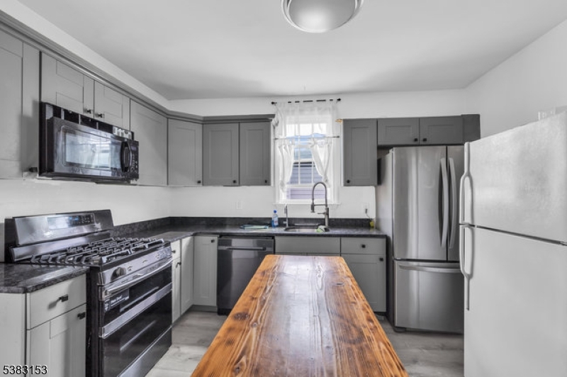 433 3rd Avenue Elizabeth Port, NJ 07206 - Photo 6 of 36 a kitchen with a refrigerator stove and sink