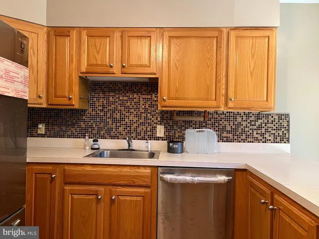 a kitchen with a sink cabinets and a window