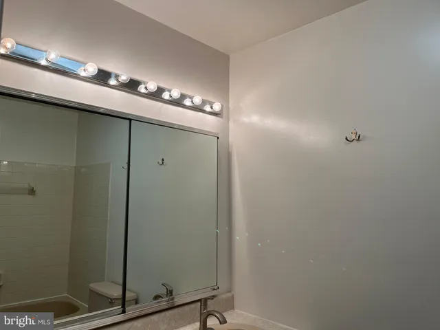 a bathroom with a mirror and a shower