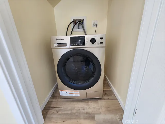 a view of a hallway with washer and dryer