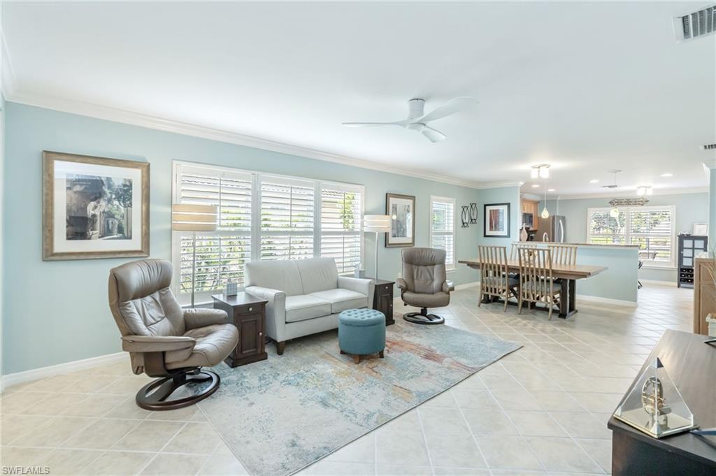 5801 Declaration Court Ave Maria, FL 34142 - Photo 5 of 38 a living room with furniture and a dining table with wooden floor