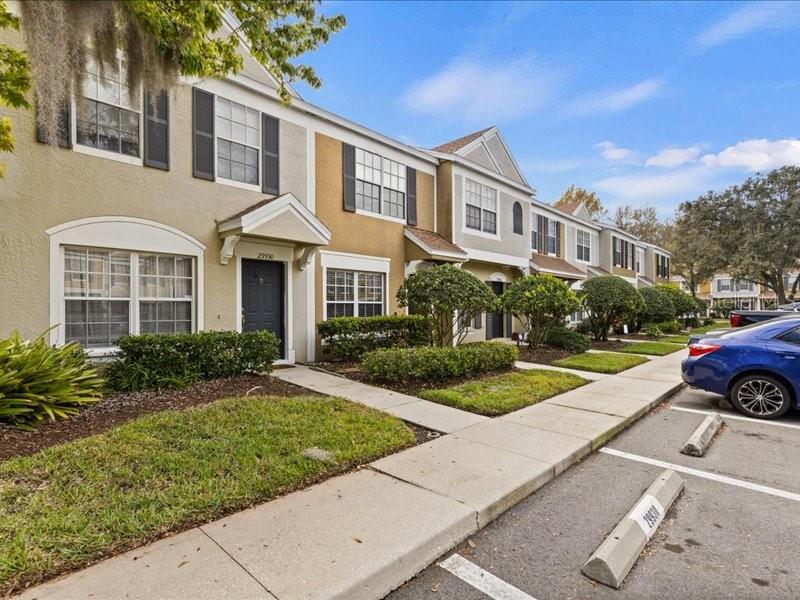 29924 Playa Del Rey Lane Wesley Chapel, FL 33543 - Photo 2 of 31 a front view of a house with yard and green space
