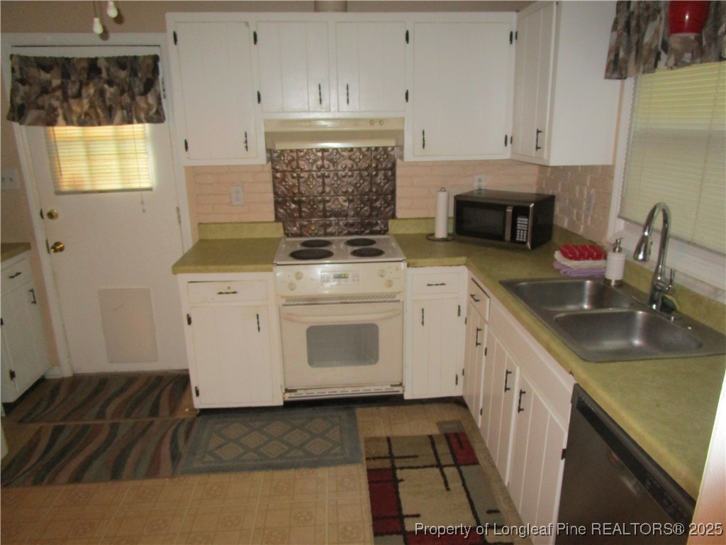 821 Rock Spring Road Fayetteville, NC 28314 - Photo 16 of 23 a kitchen with sink cabinets and stove top oven