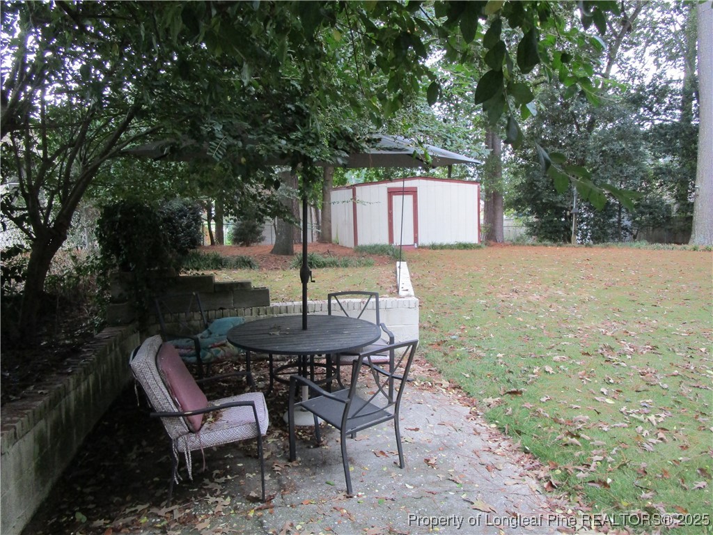 821 Rock Spring Road Fayetteville, NC 28314 - Photo 19 of 23 a backyard of a house with table and chairs