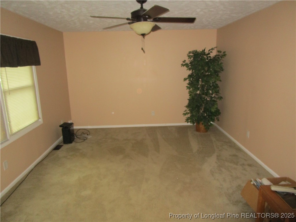 821 Rock Spring Road Fayetteville, NC 28314 - Photo 2 of 23 a view of a room with a window and a ceiling fan