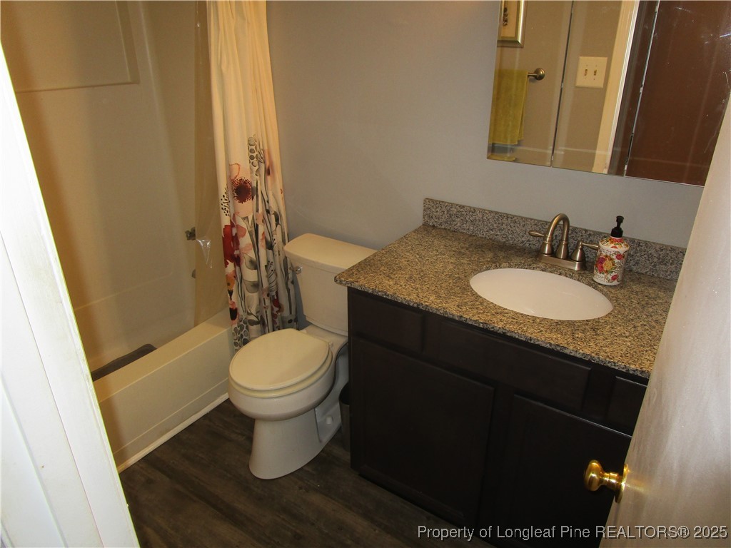 821 Rock Spring Road Fayetteville, NC 28314 - Photo 9 of 23 a bathroom with a granite countertop toilet sink and mirror
