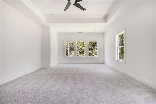 an empty room with windows and air conditioner