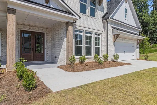 front view of a brick house with a yard