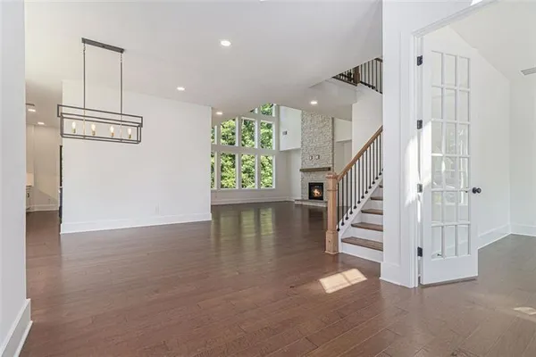 a view of entryway and hall with wooden floor