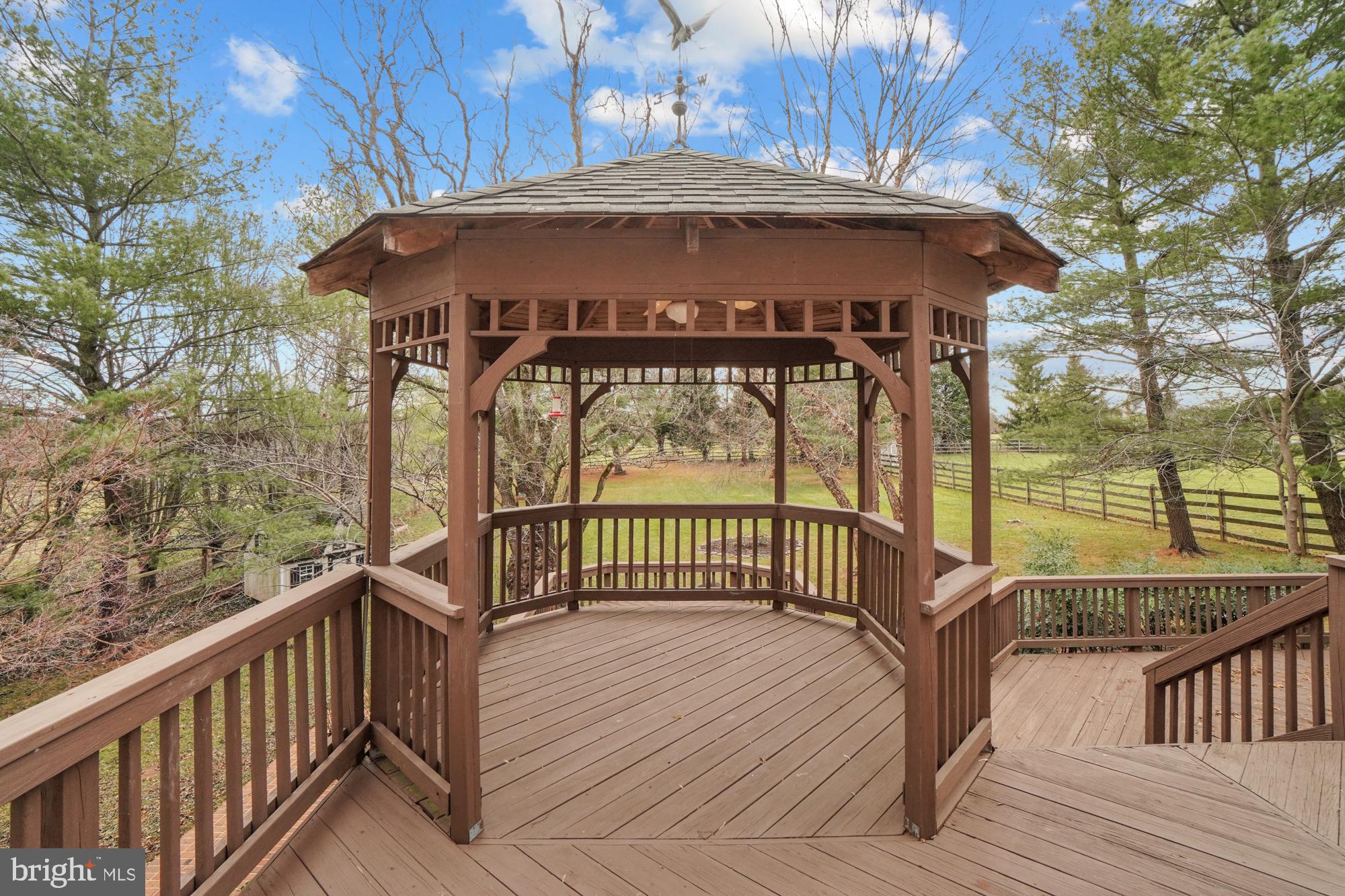 16908 Hoskinson Road Poolesville, MD 20837 - Photo 14 of 72 a view of a wooden deck with a bench